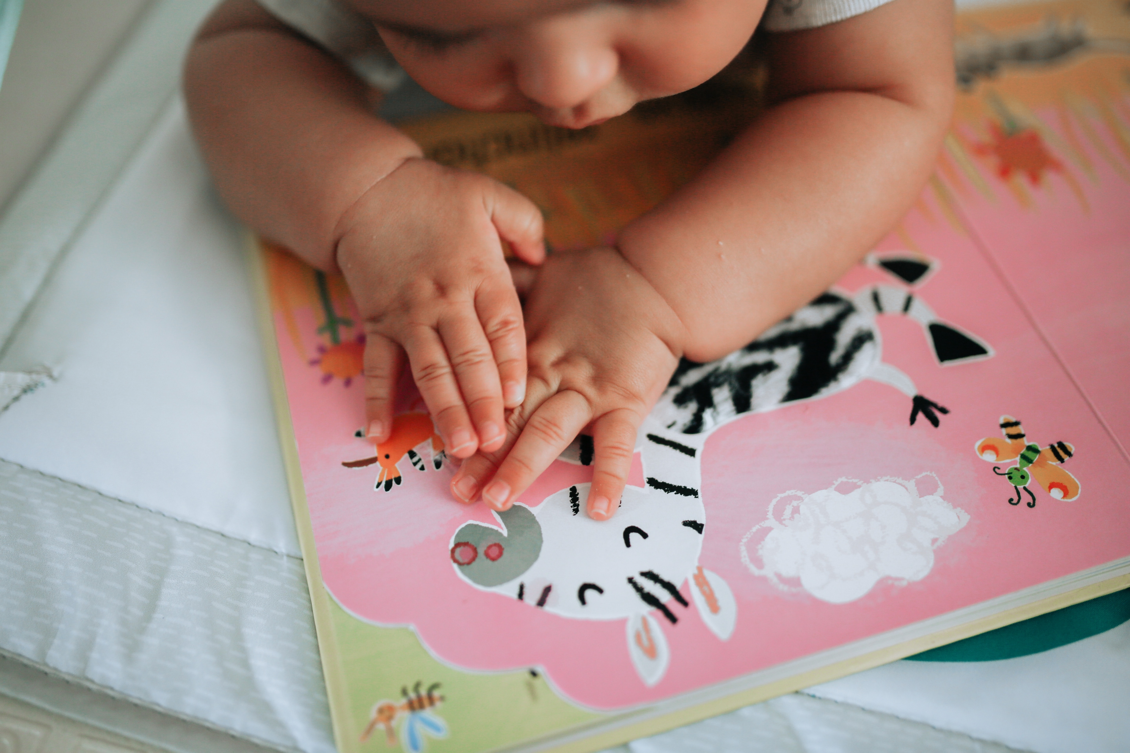 Background image of infant reading book